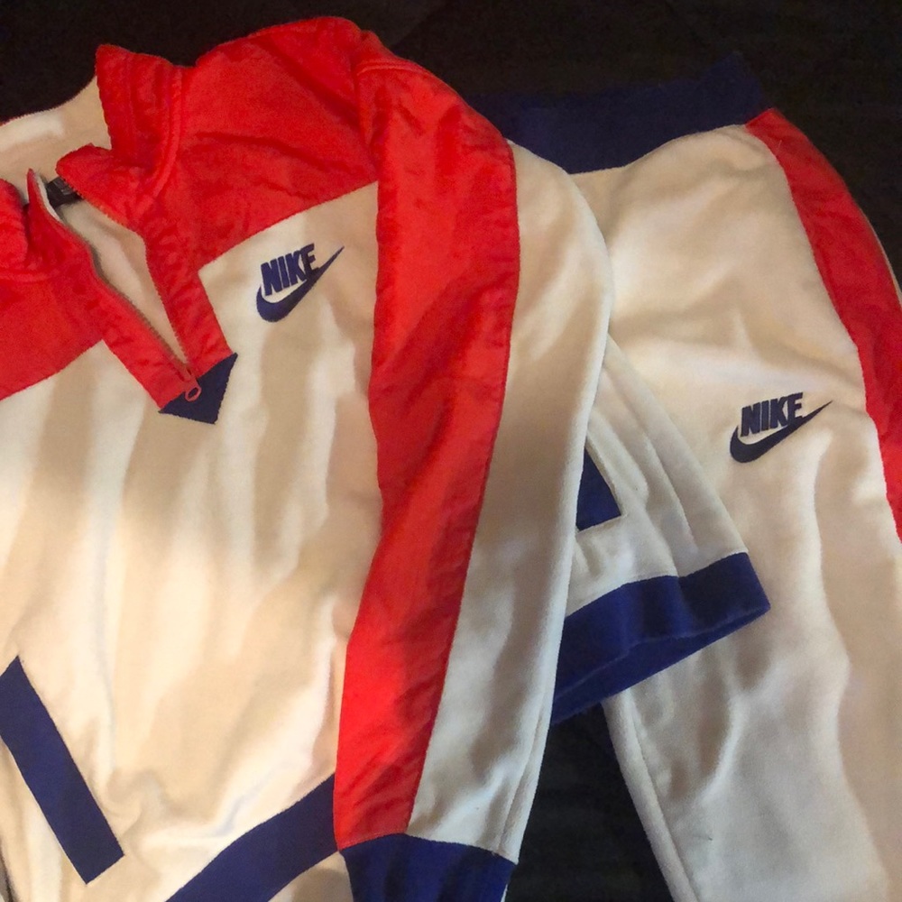 Beige orange and royal blue fleece Nike jogging set.